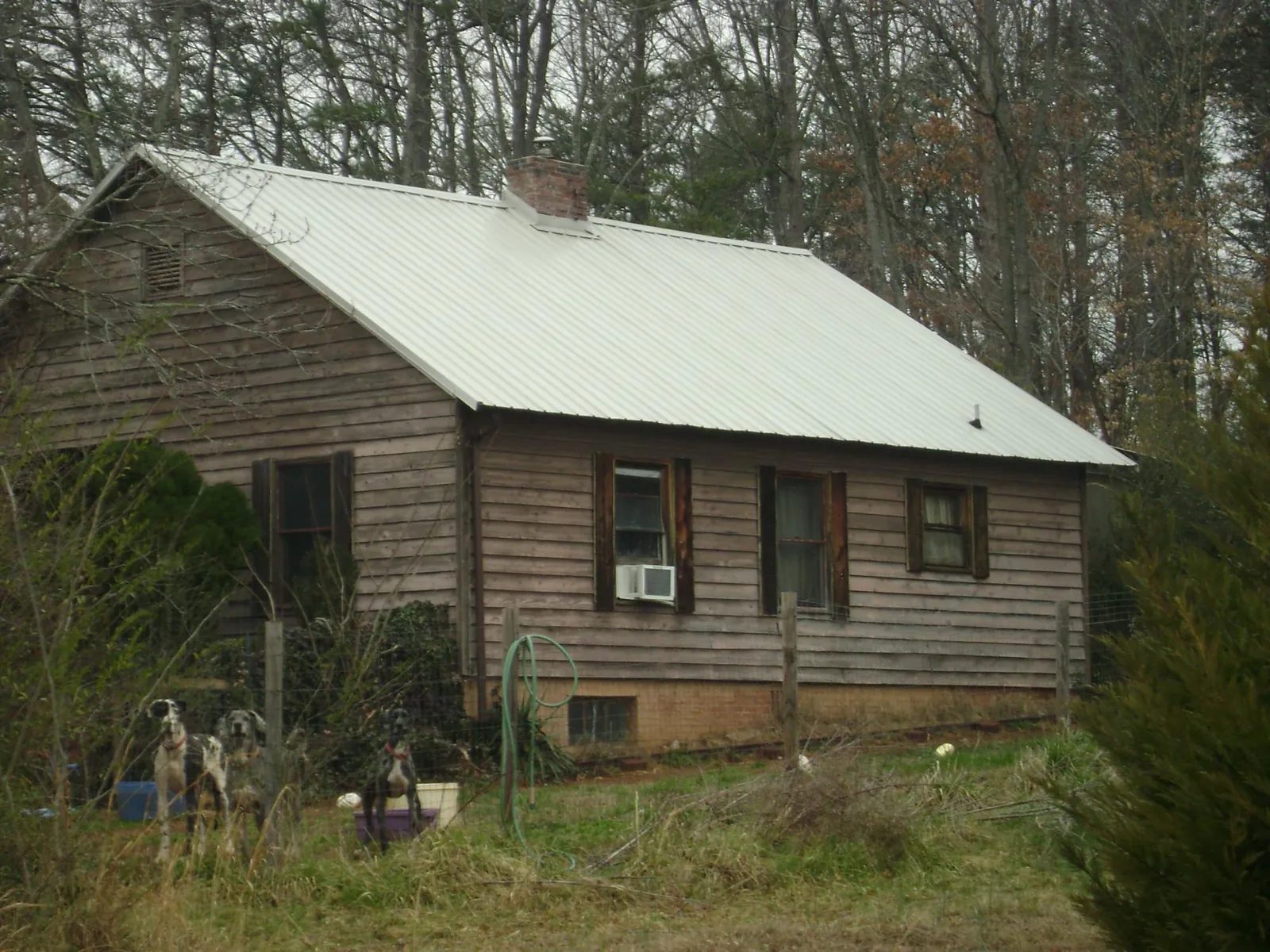 White metal roof on an old wood sided farmhouse, from a Metal Roof Installation job in Rossville